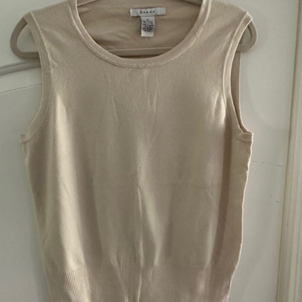 Beige, sleeveless, and lightweight sweater
